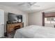 Bright main bedroom boasting a large television atop a wooden dresser, creating a comfortable and stylish retreat at 5877 N Granite Reef Rd # 2240, Scottsdale, AZ 85250
