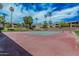 Community tennis court flanked by lush greenery and towering palm trees at 5877 N Granite Reef Rd # 2240, Scottsdale, AZ 85250