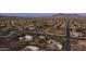 Overhead view featuring desert residences amidst lush greenery and scenic mountain backdrop at 612 N Signal Butte Rd, Mesa, AZ 85207