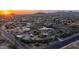 Expansive aerial view showcasing desert homes and the surrounding community at dusk at 612 N Signal Butte Rd, Mesa, AZ 85207