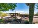 An inviting backyard retreat includes a hot tub, pergola, and tranquil desert landscape at 612 N Signal Butte Rd, Mesa, AZ 85207