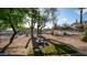 The expansive yard features desert landscaping and a dog run; perfect for outdoor enjoyment at 612 N Signal Butte Rd, Mesa, AZ 85207