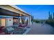 Backyard patio with desert landscape and white curtained pergola, offering a relaxing outdoor space at 612 N Signal Butte Rd, Mesa, AZ 85207