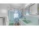 This charming bathroom has a vintage sink and bathtub with aqua tiling and white walls at 612 N Signal Butte Rd, Mesa, AZ 85207