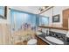 Stylish bathroom with a granite countertop, desert themed shower curtain, and updated fixtures at 612 N Signal Butte Rd, Mesa, AZ 85207