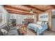 Cozy bedroom featuring a brick fireplace, wood ceiling, and comfortable sitting area with a sofa at 612 N Signal Butte Rd, Mesa, AZ 85207