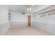 This bedroom has wood paneled walls, tile floors and a ceiling fan at 612 N Signal Butte Rd, Mesa, AZ 85207