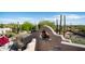 Southwestern courtyard view features a stucco wall with trees, cacti, and mountain views beyond at 612 N Signal Butte Rd, Mesa, AZ 85207