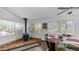 Bright dining area with wood-burning stove, glass table, and natural lighting at 612 N Signal Butte Rd, Mesa, AZ 85207