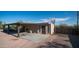 A combination of carport, storage building, and desert landscape create a backyard utility space at 612 N Signal Butte Rd, Mesa, AZ 85207