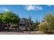 View of the house nestled amongst lush desert vegetation at 612 N Signal Butte Rd, Mesa, AZ 85207