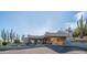 Exterior shot featuring desert landscaping, a covered drive, and a Southwestern aesthetic at 612 N Signal Butte Rd, Mesa, AZ 85207