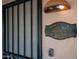 Close-up of front door with security bars and a welcoming sign, set in a secure and charming entry at 612 N Signal Butte Rd, Mesa, AZ 85207