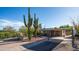 Charming desert home with a covered entryway, carport, and desert landscaping with saguaro cacti, on a sunny day at 612 N Signal Butte Rd, Mesa, AZ 85207