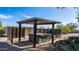 Relax under the pergola near the hot tub with privacy screens and desert views at 612 N Signal Butte Rd, Mesa, AZ 85207