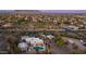 Stunning aerial view of a neighborhood nestled amidst lush greenery and majestic mountains at 612 N Signal Butte Rd, Mesa, AZ 85207