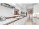Bright kitchen featuring white cabinetry, an electric stove, and a vintage aesthetic at 612 N Signal Butte Rd, Mesa, AZ 85207