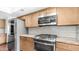 Updated kitchen featuring stainless steel appliances and granite counters at 612 N Signal Butte Rd, Mesa, AZ 85207