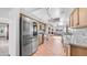 Updated kitchen boasting stainless steel appliances, granite counters, and terra-cotta flooring at 612 N Signal Butte Rd, Mesa, AZ 85207