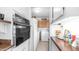 This kitchen features a laundry area with a washer, dryer, and pantry space at 612 N Signal Butte Rd, Mesa, AZ 85207
