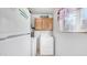 Clean laundry area with natural light, includes washer, dryer, and overhead storage at 612 N Signal Butte Rd, Mesa, AZ 85207