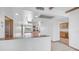 Bright and spacious living room featuring terra-cotta tiled floors and seamless access to kitchen at 612 N Signal Butte Rd, Mesa, AZ 85207