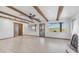 Bright living room featuring beamed ceilings, Saltillo tile flooring, and views of the surrounding desert landscape at 612 N Signal Butte Rd, Mesa, AZ 85207
