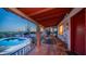 Covered patio overlooking the pool features a red-beamed ceiling and comfortable seating with beautiful views at 612 N Signal Butte Rd, Mesa, AZ 85207