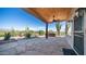 Covered patio with stone flooring and desert landscaping at 612 N Signal Butte Rd, Mesa, AZ 85207