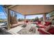 Covered patio with red cushioned seating, providing a relaxing outdoor space with desert views at 612 N Signal Butte Rd, Mesa, AZ 85207