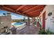 Spacious patio with pool views and comfortable seating with a charming view of the landscape at 612 N Signal Butte Rd, Mesa, AZ 85207