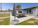 Comfortable back patio area with an umbrella, and table with seating for six at 615 E Mckellips Rd, Tempe, AZ 85288