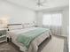 Bright bedroom with a queen-sized bed, ceiling fan, and natural light from the window at 615 E Mckellips Rd, Tempe, AZ 85288