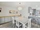 Bright dining area with modern chandelier, sleek gray cabinets, and adjacent kitchen island at 615 E Mckellips Rd, Tempe, AZ 85288
