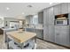 Spacious kitchen featuring modern appliances, a center island, and sleek gray cabinets at 615 E Mckellips Rd, Tempe, AZ 85288