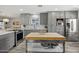 Spacious kitchen featuring modern appliances, a center island, and sleek gray cabinets at 615 E Mckellips Rd, Tempe, AZ 85288