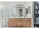Well-lit bathroom featuring a double vanity, walk-in shower, and closet, providing convenience and organization at 6331 S Cypress Point Dr, Chandler, AZ 85249