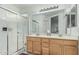 Bright bathroom with double sinks, walk-in shower, and ample cabinet space, offering a clean and functional design at 6331 S Cypress Point Dr, Chandler, AZ 85249