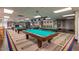 Large billiard room featuring multiple pool tables, overhead lighting, and decorative accents at 6331 S Cypress Point Dr, Chandler, AZ 85249