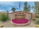 Landscaped sign for Sunbird Golf Resort with colorful flowers in front at 6331 S Cypress Point Dr, Chandler, AZ 85249