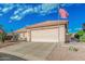 Home exterior featuring a two-car garage and desert landscaping at 6331 S Cypress Point Dr, Chandler, AZ 85249