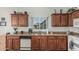 Bright kitchen boasts wood cabinetry, granite countertops, dishwasher, and a view of the neighborhood at 6331 S Cypress Point Dr, Chandler, AZ 85249