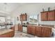 Cozy kitchen features granite countertops, wood cabinets, and a view of the neighborhood from the window at 6331 S Cypress Point Dr, Chandler, AZ 85249