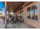 Comfortable covered patio with neutral toned furniture with access to backyard at 6331 S Cypress Point Dr, Chandler, AZ 85249
