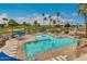 Beautiful swimming pool with clear water, patio seating, and lush palm trees, all with golf course views at 6331 S Cypress Point Dr, Chandler, AZ 85249