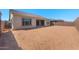 Spacious backyard with block wall and covered patio with exterior of home at 662 W Rock Needle Trl, Apache Junction, AZ 85120