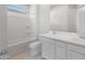Clean and bright bathroom with dual vanity, bathtub and shower combination at 662 W Rock Needle Trl, Apache Junction, AZ 85120