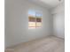 Cozy carpeted bedroom featuring a closet and a bright window at 662 W Rock Needle Trl, Apache Junction, AZ 85120