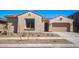 Charming single-story home with stucco siding, tile roof, desert landscaping, and attached garage at 662 W Rock Needle Trl, Apache Junction, AZ 85120