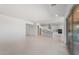 Bright, open floor plan featuring a modern kitchen with white cabinets, island, and stainless steel appliances at 662 W Rock Needle Trl, Apache Junction, AZ 85120